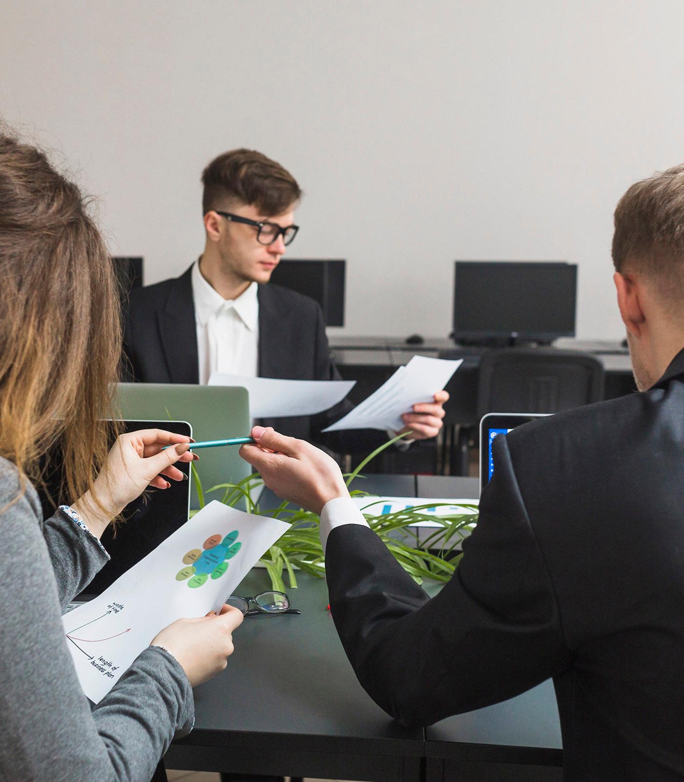 Business professionals analyzing sustainability data during an ESG strategy meeting.