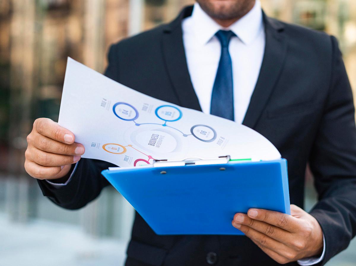Man reviewing ESG and sustainability report with charts.